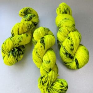 Hand-dyed Superwash DK Weight Yarn 'Biohazard'. Fluorescent Yellow with Steel Blue Speckles.